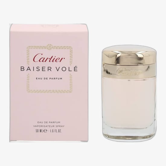 Elegant Cartier Baiser Volé EDP spray sample close-up with soft floral background