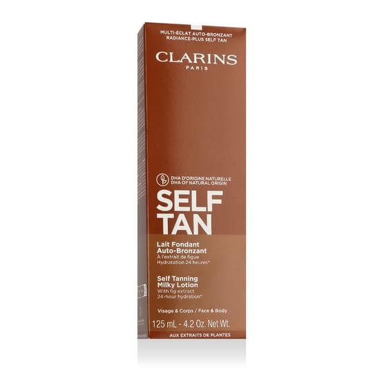 Bottle of clarins self tanning milky lotion on a white background