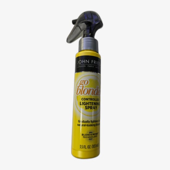 John Frieda Blonde Go Lightening Spray pudel heledal taustal