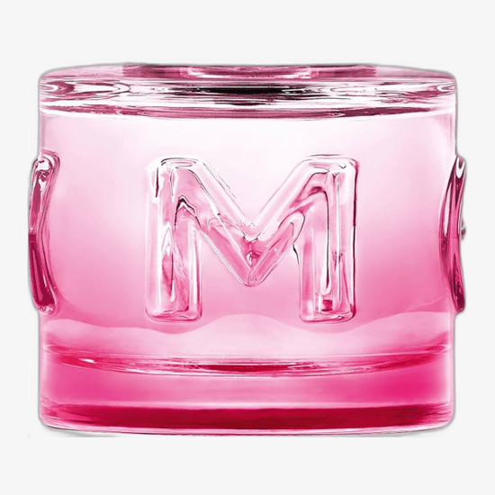 The bottle of Mexx Summer Holiday Woman EDT against a beach backdrop