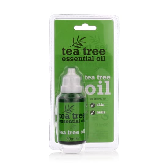 Bottle of xpel tea tree essential oil on a wooden surface