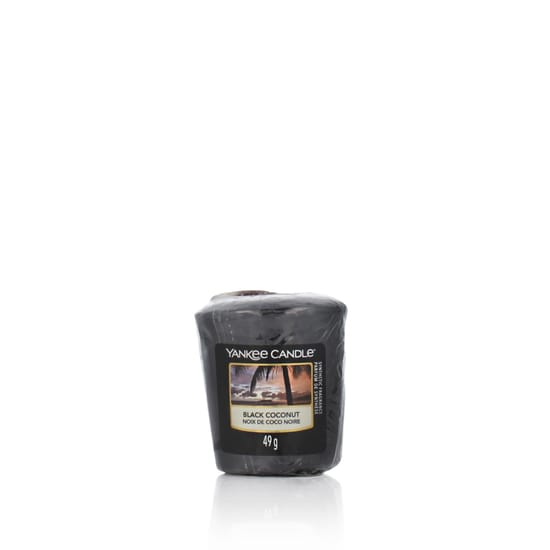 Close-up of yankee candle black coconut scented votive candle