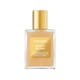 Elegant bottle of Tom Ford Soleil Blanc Shimmering Body Oil radiating a golden shimmer