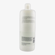 Флакон Wella Nutricurls Waves & Curls Cleansing Conditioner на фоне локонов